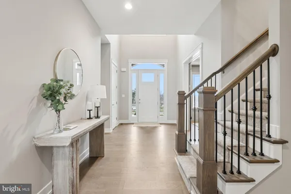 a view of an entryway with wooden floor and stairs