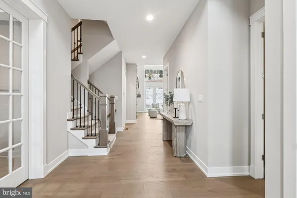 a view of entryway and hall with wooden floor