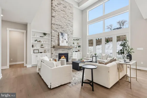 a living room with furniture a fireplace and a painting