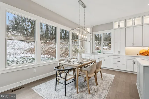 a dining room with furniture a chandelier and wooden floor