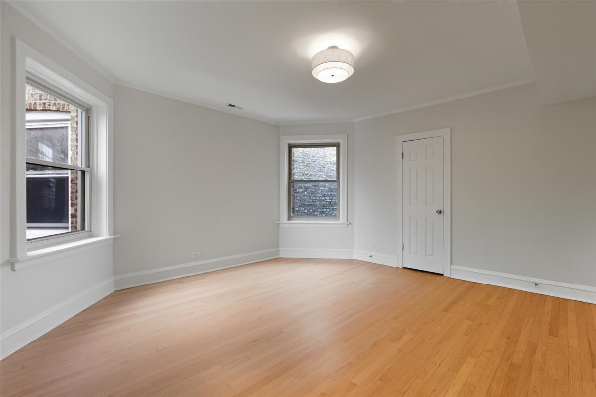 6136 North Mozart Street, Unit 4 Chicago, IL 60659 - Photo 7 of 10 a view of an empty room with a window and closet area