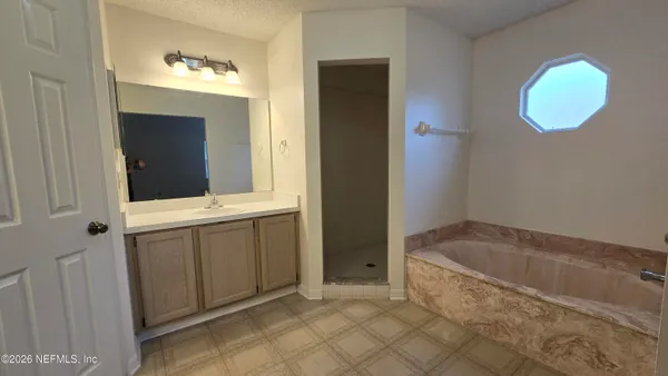 a bathroom with a bathtub and a sink