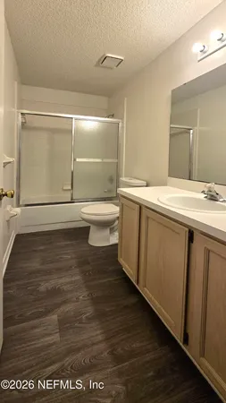 a bathroom with a sink a toilet and mirror