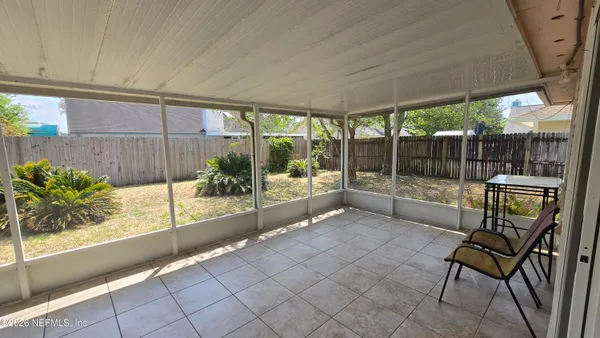 a view of a chairs and table in backyard