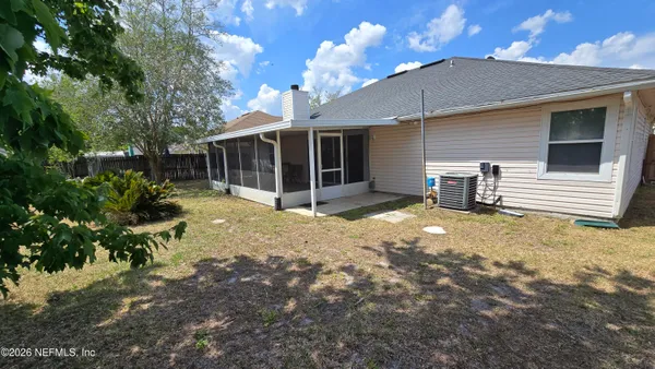 a view of a house with a yard and sitting area