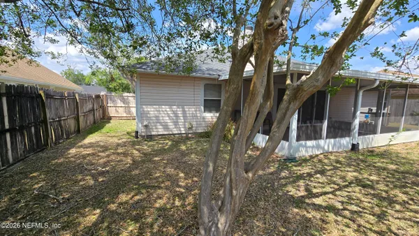 a view of a house with a tree in front of it