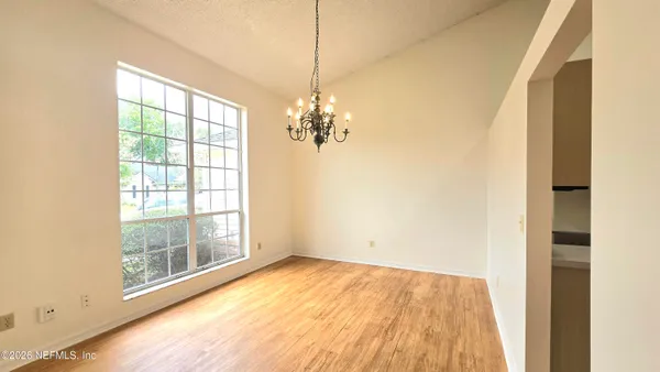 a view of a room with wooden floor and windows