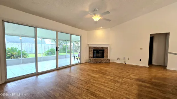 a view of empty room with window and fireplace