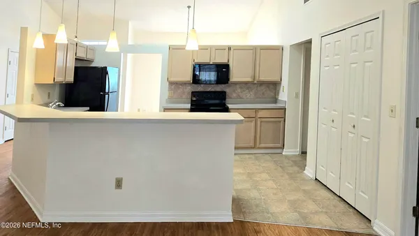 a kitchen with stainless steel appliances a refrigerator stove and microwave