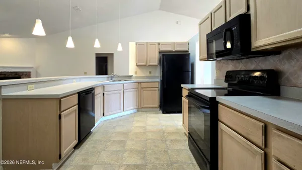 a kitchen with a sink and a refrigerator