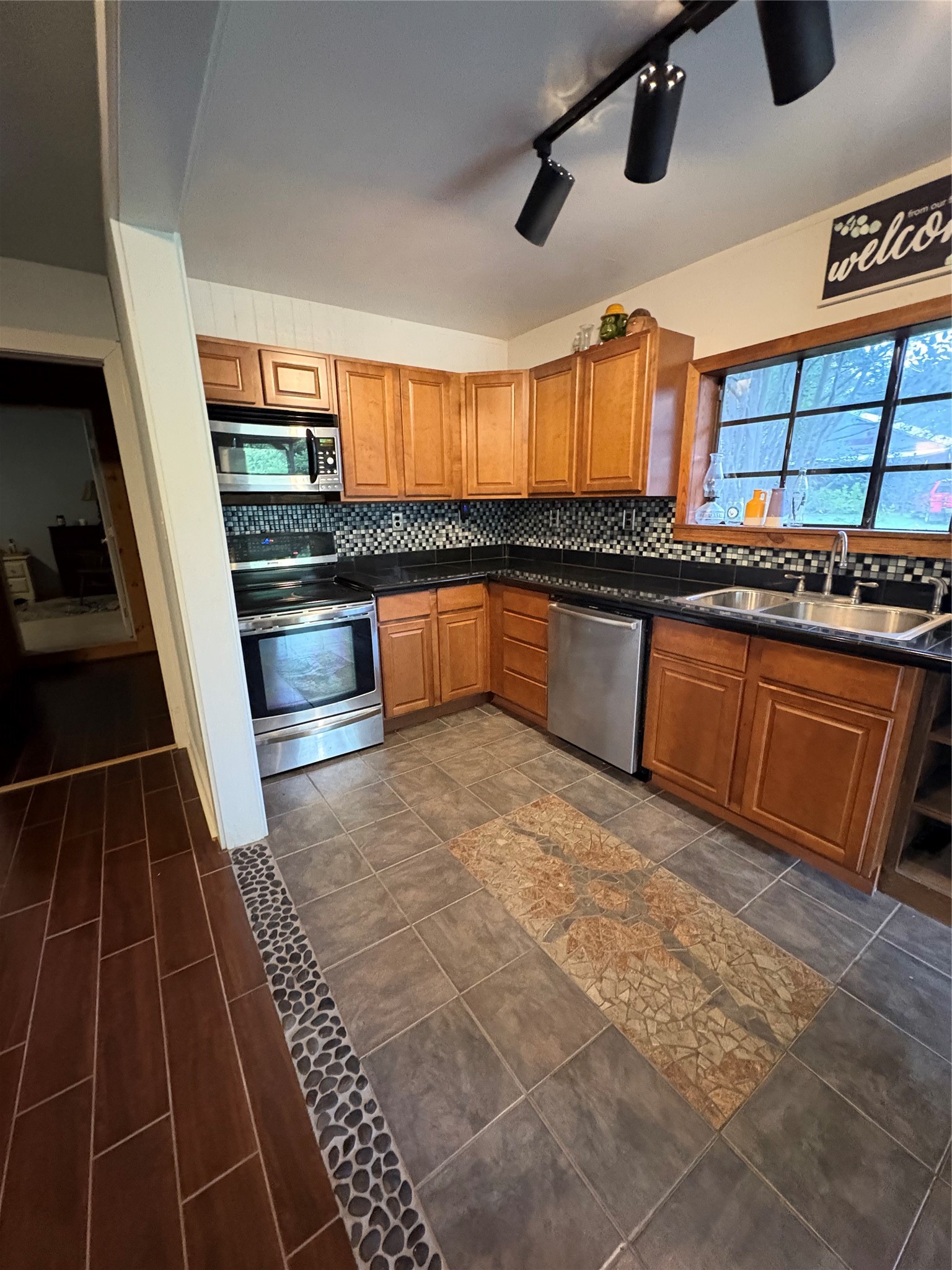 550 Dogwood Road Cleveland, TX 77328 - Photo 27 of 49 a kitchen with stainless steel appliances granite countertop a sink and a stove