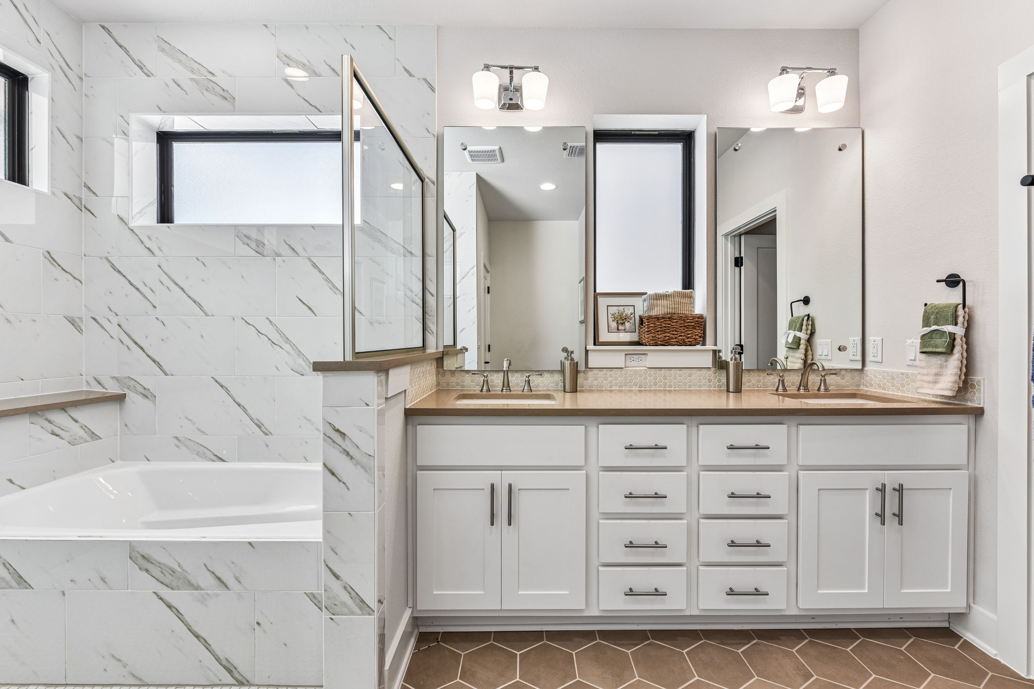 9033 Cattle Baron Path Austin, TX 78747 - Photo 33 of 40 Indulge in a primary bathroom featuring a spacious soaking tub and an elegant dual vanity with ample storage.