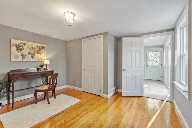 a view of a room with furniture and wooden floor