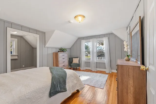 a bedroom with a bed and a large window with balcony view