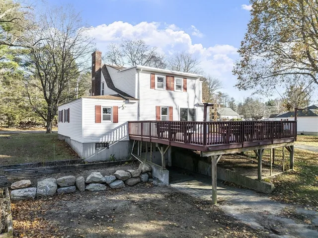a view of a house with backyard porch and sitting area