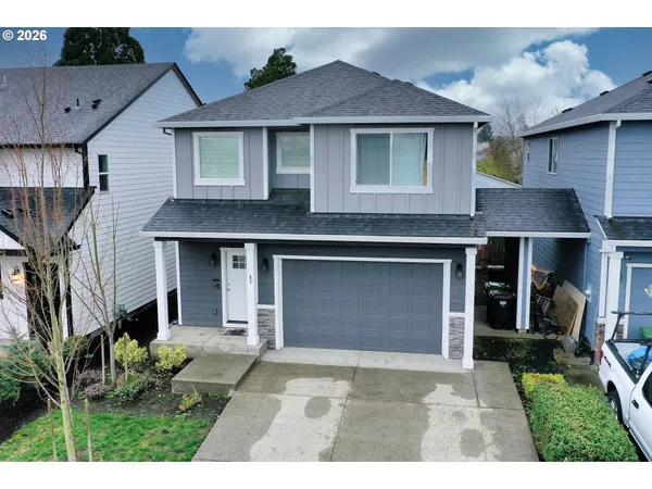 a front view of a house with a yard and garage