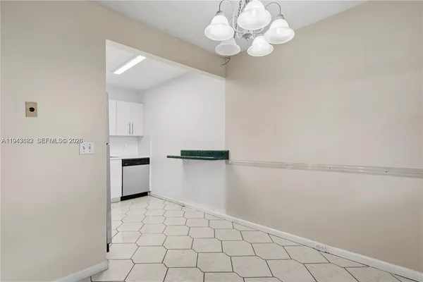 a view of a kitchen with white cabinets