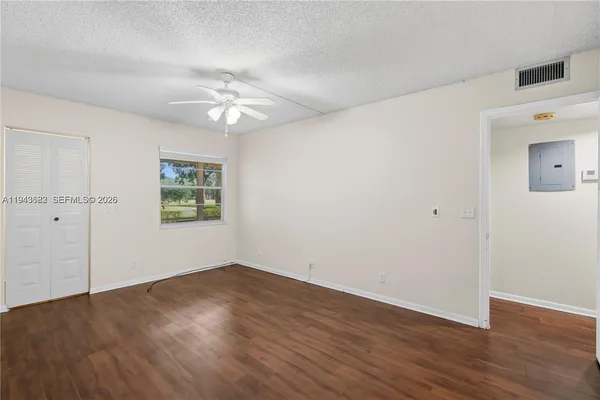 wooden floor in an empty room with a window