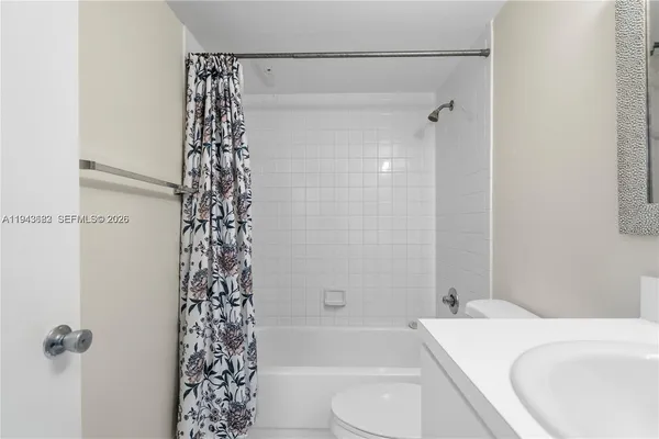 a bathroom with a shower curtain and a toilet