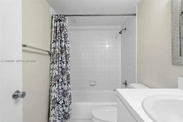 a bathroom with a shower curtain and a toilet