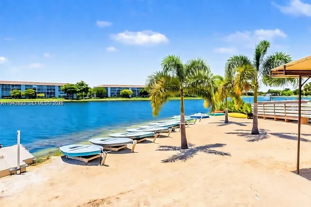 an aerial view of a residential houses with street and trees