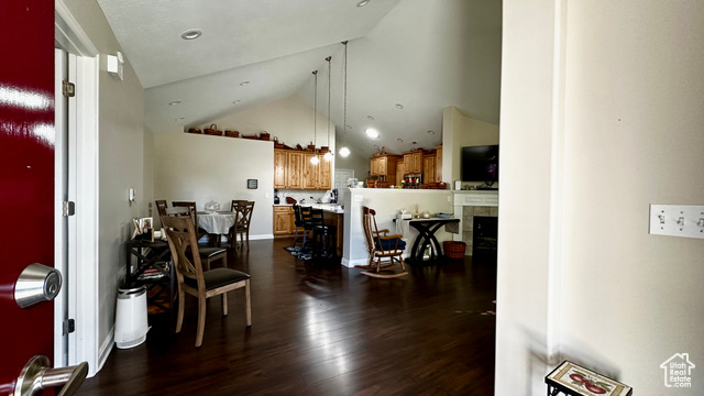 929 West 1920 South, Unit A Syracuse, UT 84075 - Photo 5 of 26 Dining room featuring high vaulted ceiling, a fireplace, and dark hardwood / wood-style flooring