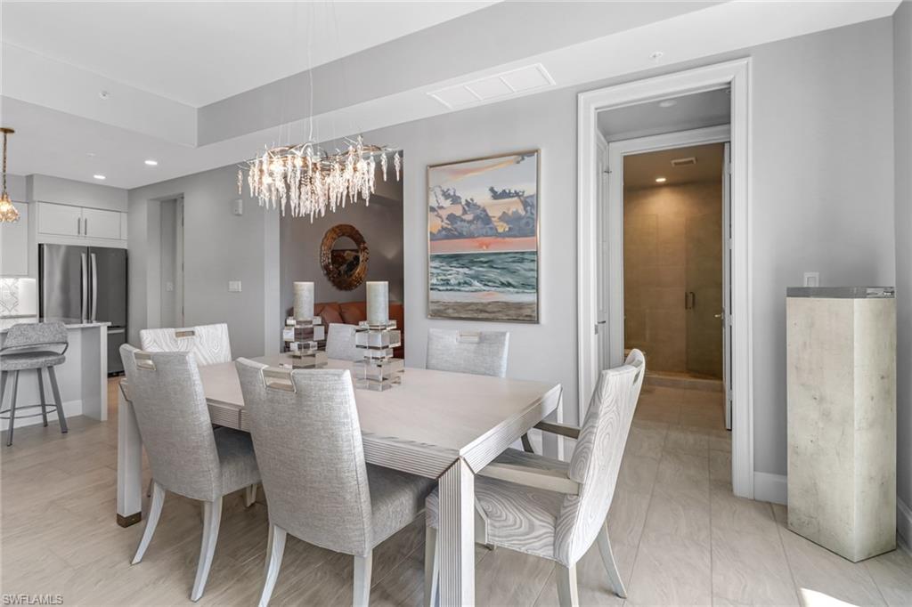 1111 Central Avenue, Unit 203 Naples, FL 34102 - Photo 5 of 19 a view of a dining room with furniture and a large window