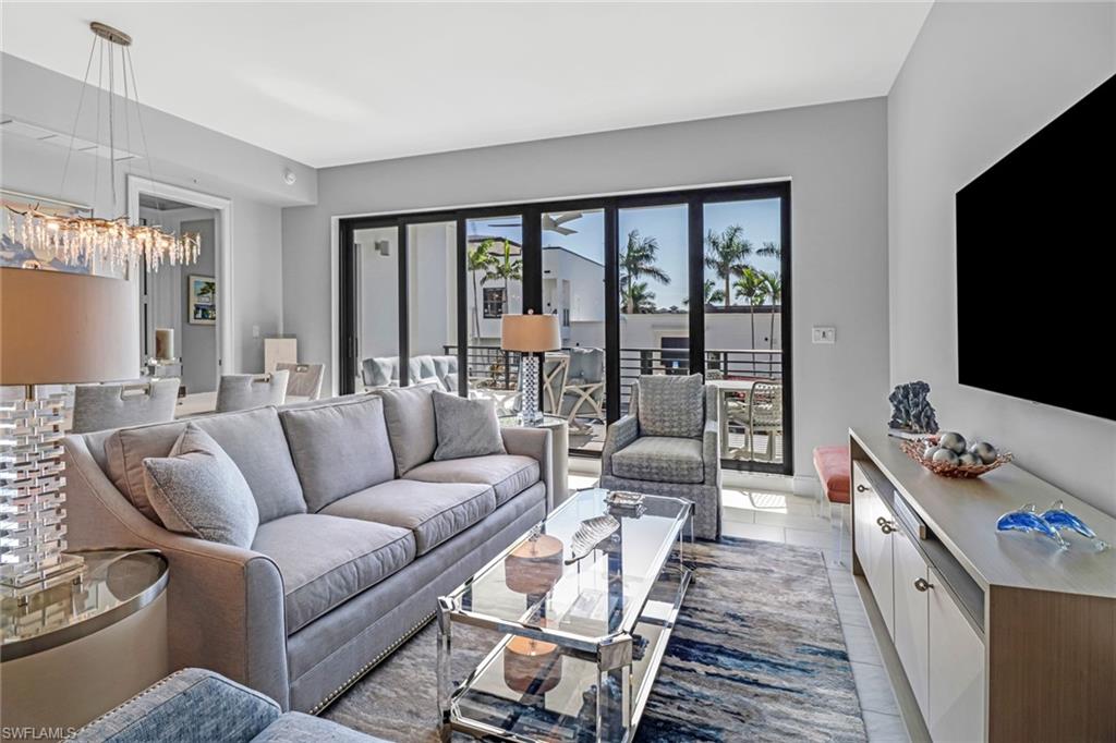 1111 Central Avenue, Unit 203 Naples, FL 34102 - Photo 7 of 19 a living room with furniture and a flat screen tv