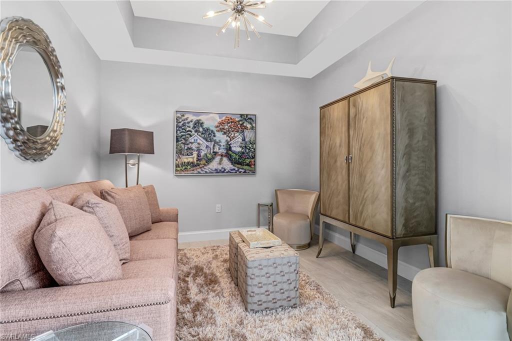 1111 Central Avenue, Unit 203 Naples, FL 34102 - Photo 8 of 19 a living room with furniture and a painting on the wall