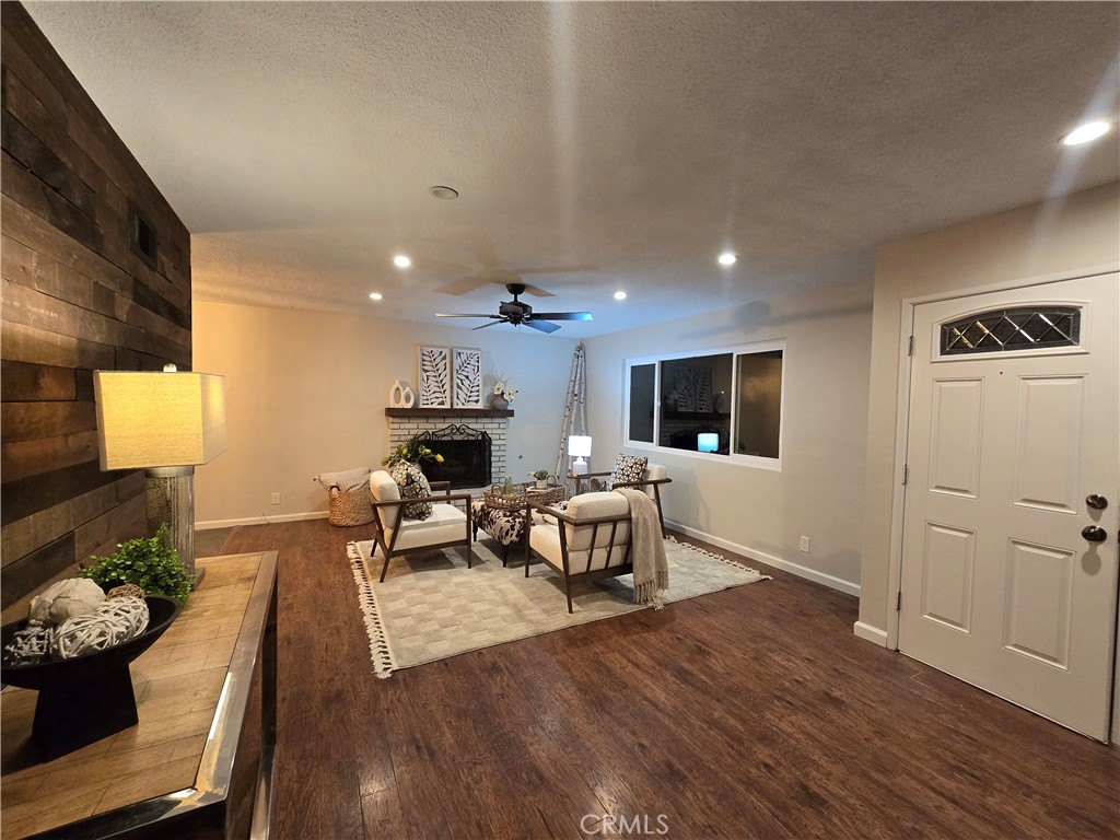 607 Sixth Street Norco, CA 92860 - Photo 14 of 31 a living room with furniture a flat screen tv and a wooden floor