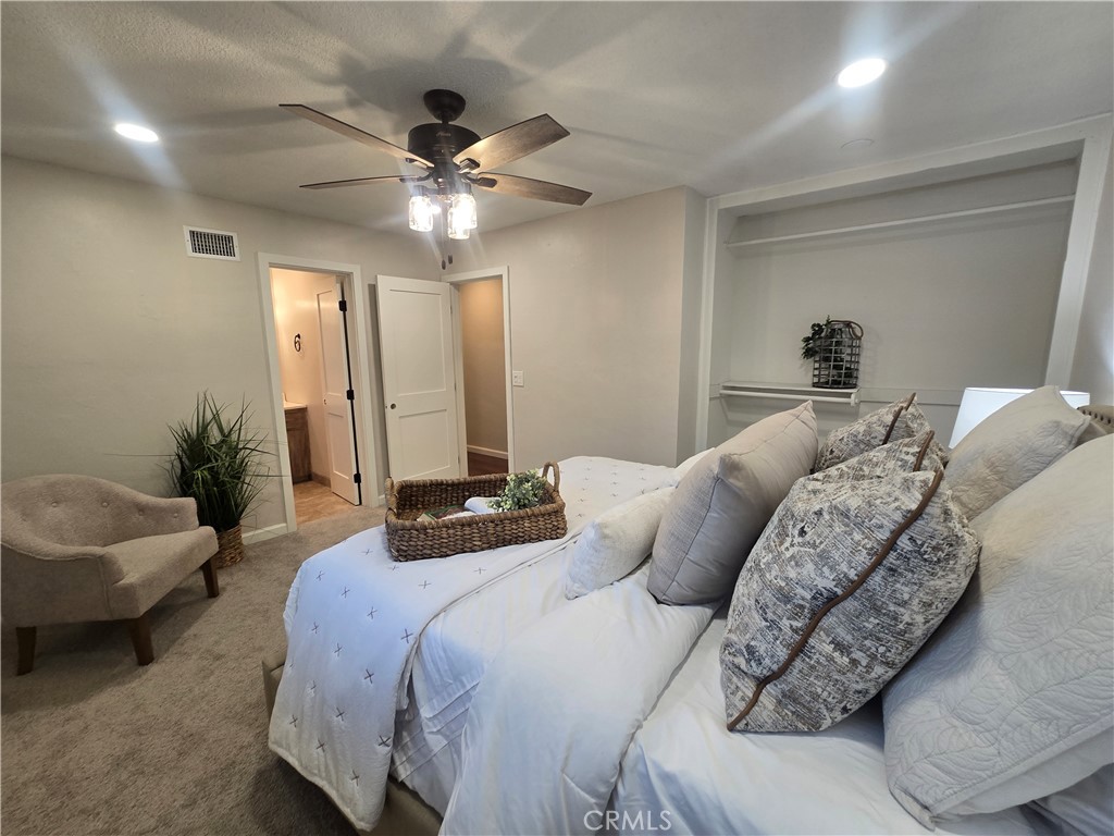 607 Sixth Street Norco, CA 92860 - Photo 20 of 31 a bedroom with a large bed and a chandelier