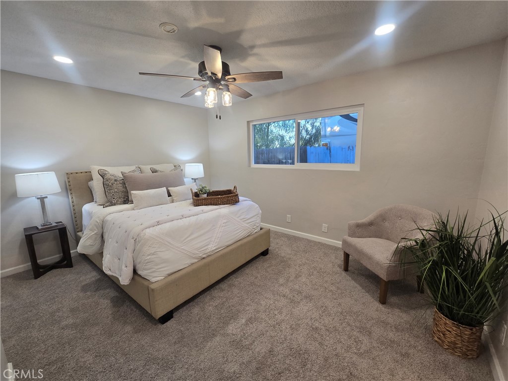 607 Sixth Street Norco, CA 92860 - Photo 21 of 31 a bedroom with a bed and a chandelier