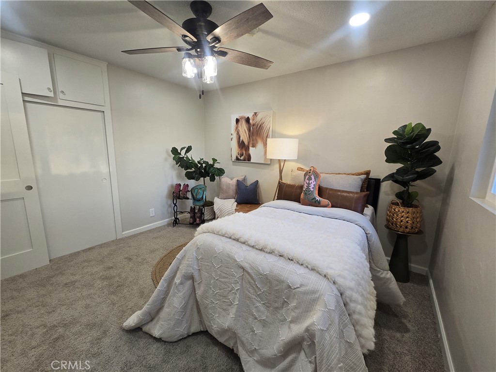 607 Sixth Street Norco, CA 92860 - Photo 23 of 31 a bedroom with a bed and a chandelier