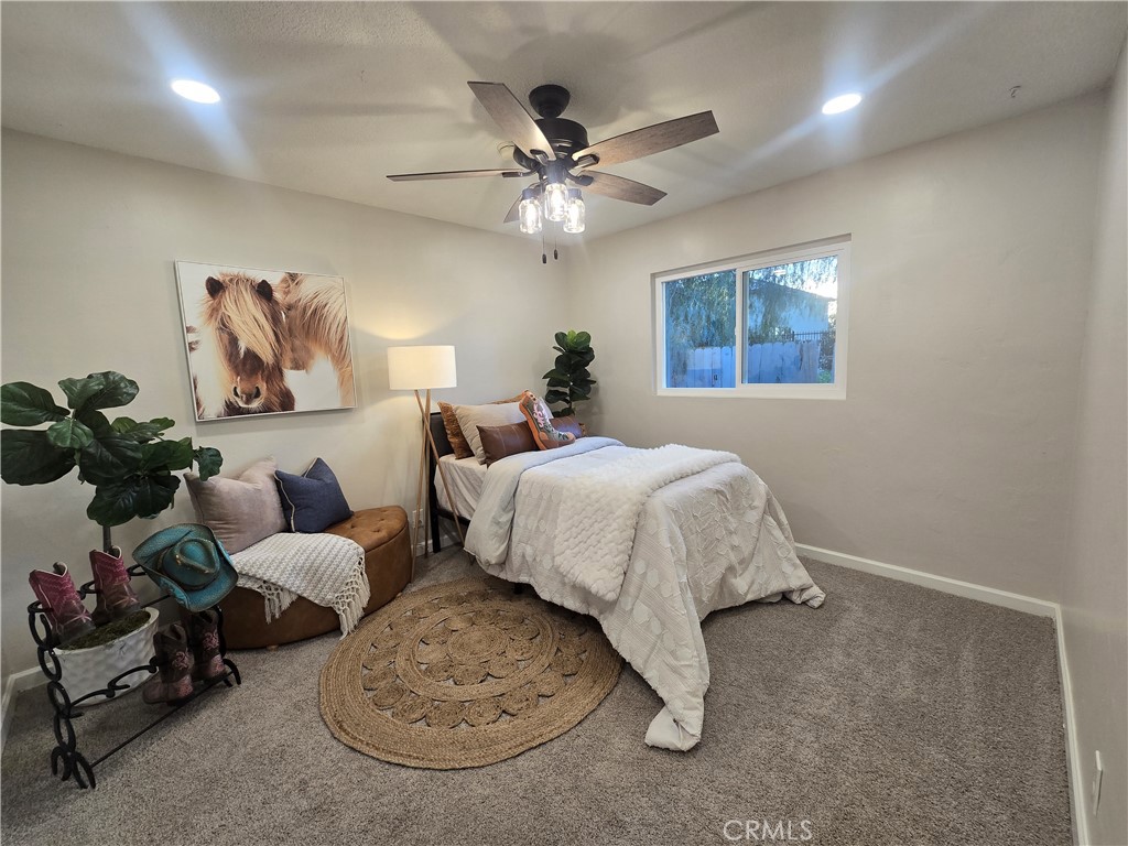 607 Sixth Street Norco, CA 92860 - Photo 24 of 31 a bed room with a bed and a chandelier