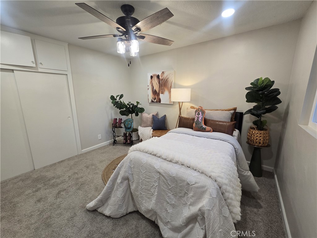 607 Sixth Street Norco, CA 92860 - Photo 27 of 31 a bedroom with a bed and a chandelier