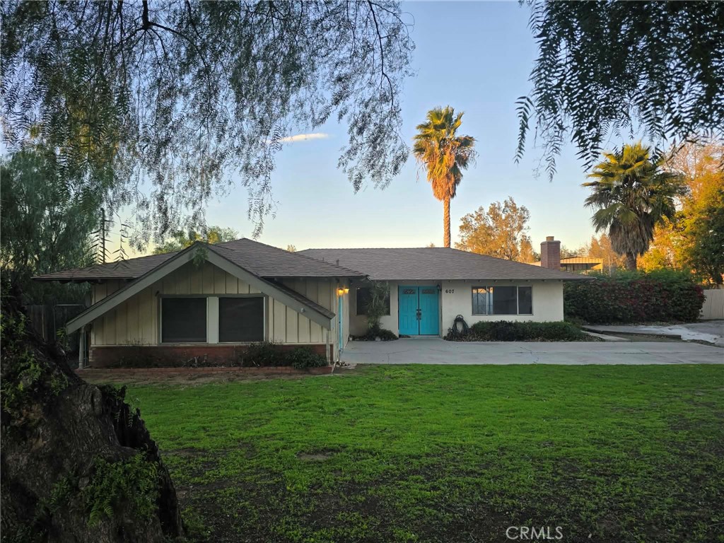 607 Sixth Street Norco, CA 92860 - Photo 30 of 31 a front view of a house with a garden and yard
