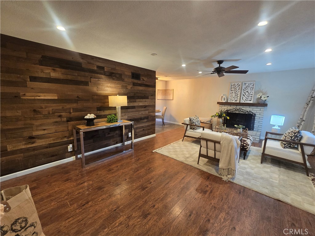607 Sixth Street Norco, CA 92860 - Photo 4 of 31 a living room with furniture a fireplace and a flat screen tv