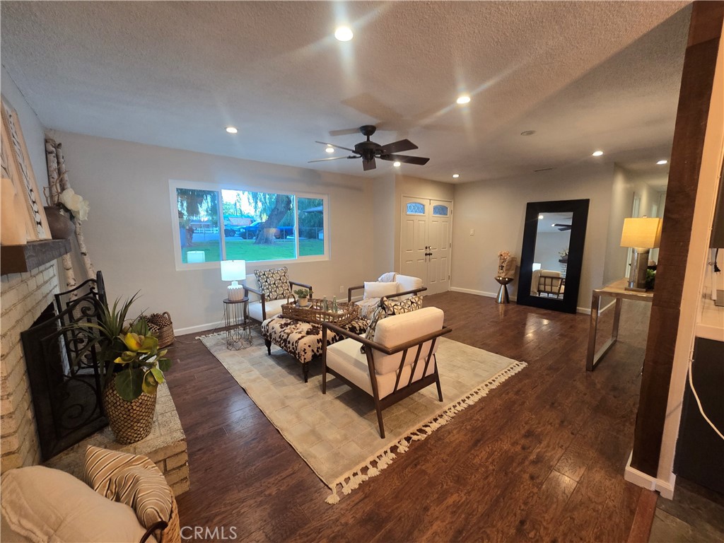 607 Sixth Street Norco, CA 92860 - Photo 7 of 31 a living room with furniture a chandelier and a flat screen tv