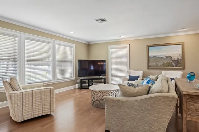 a view of a livingroom with furniture window and wooden floor
