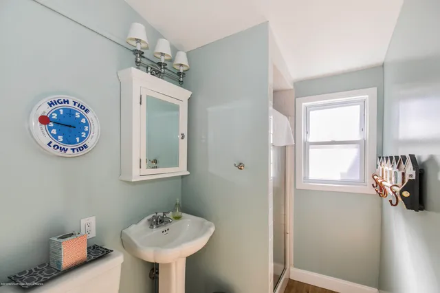 a bathroom with a sink a mirror and a window