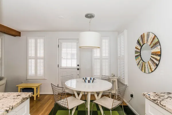 a view of a dining room with furniture and a window