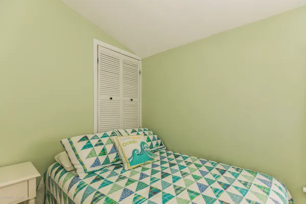 a bedroom with a bed and a chair