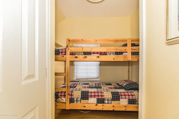 a bedroom with a bed and a table with chair