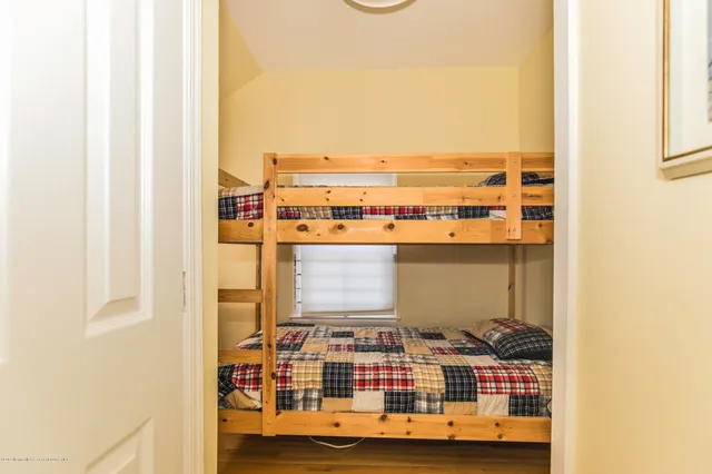 a bedroom with a bed and a table with chair