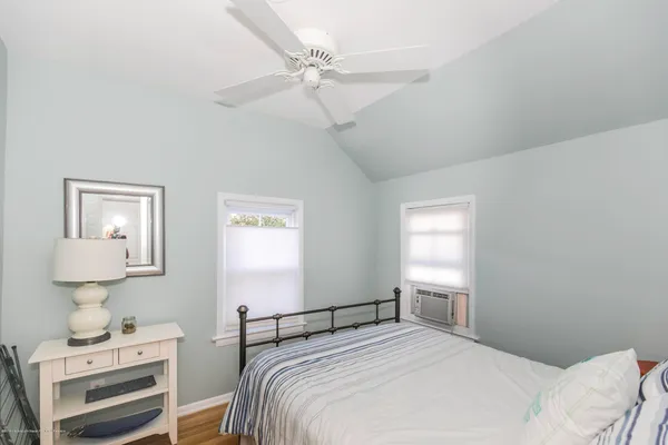 a bedroom with a bed and a lamp on table