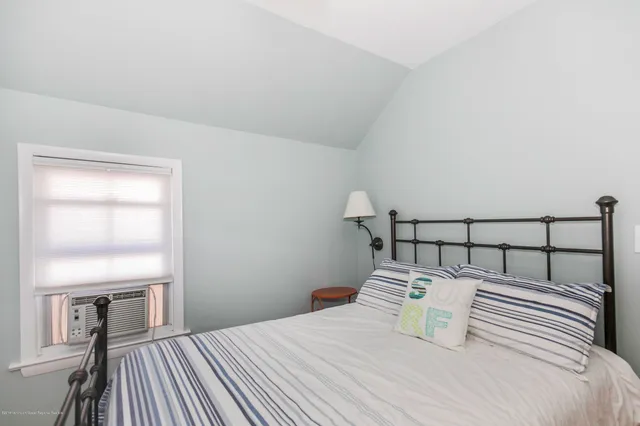 a bedroom with a bed and a lamp