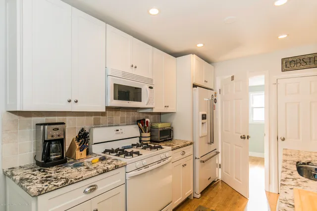 a kitchen with stainless steel appliances granite countertop a stove and a refrigerator