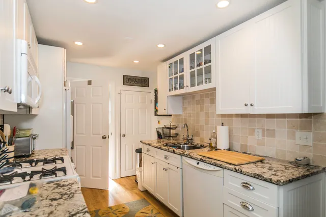 a kitchen with a sink stove and refrigerator