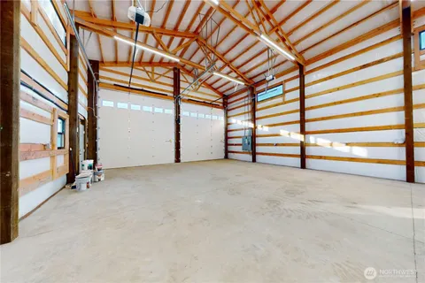 a view of a room with gym equipment and large window