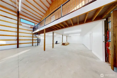 an empty room with windows and stairs